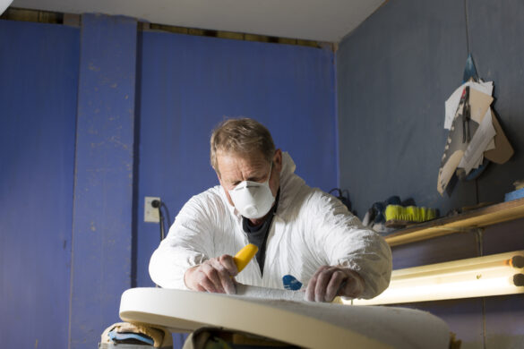 Graham Carse shapes a surfboard in his Quarry Beach Surf Shop shaping bay, Dunedin, New Zealand.