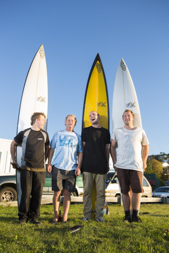 Graham Carse hands over three new big wave surfboards to Jimi Crooks, Tom Bracegirdle and Leroy Rust at the Quarry Beach surfboard factory in March 2013. Photo: Derek Morrison