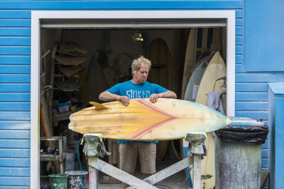 Graham Carse checks out Justin Courtney's restoration Wayne Parkes at Quarry Beach Surfboards,  St Clair, Dunedin, New Zealand.