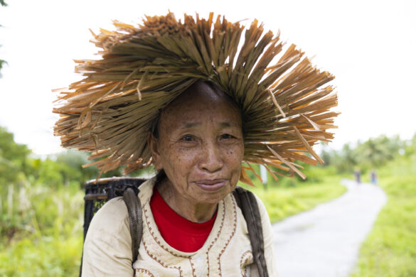 An elderly villager on her way home from work.